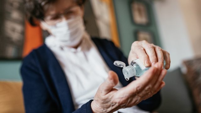 woman using hand sanitizer