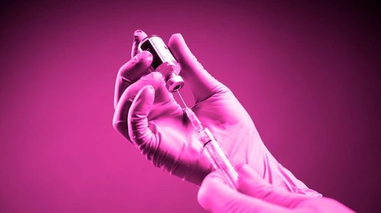 Doctor wearing Surgical gloves and preparing the coronavirus COVID-19 vaccine (2019-nCoV) first Coronavirus vaccine found in the world with red background isolated Myths-About-The-Vaccine-And-Infertility